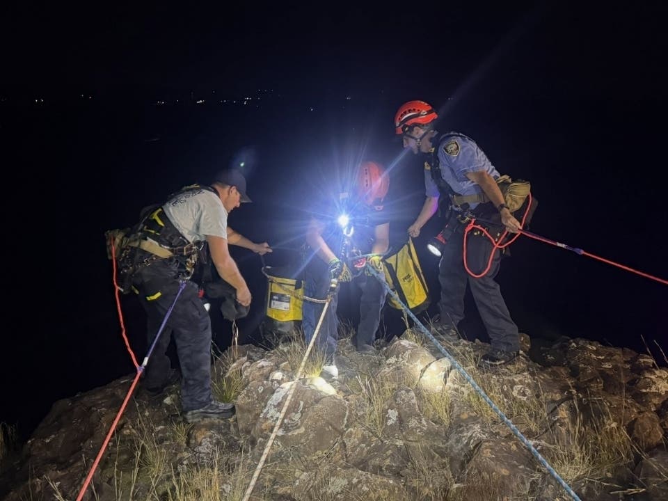 Specially trained Southington Fire Department rescuers work to help a stranded hiker atop an 80-foot cliff late last week on Ragged Mountain.