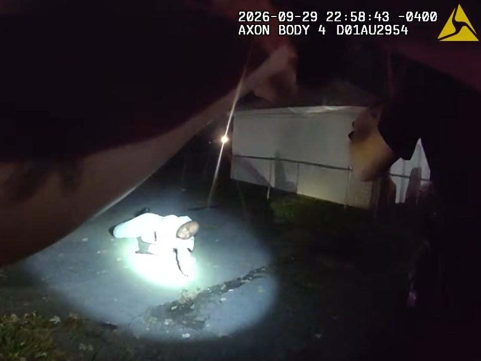 Middletown homicide suspect Barrington Brown, 43, lies on the ground with a wounded shoulder as three West Hartford police officers surround him as seen in the body camera still from one of the officers.