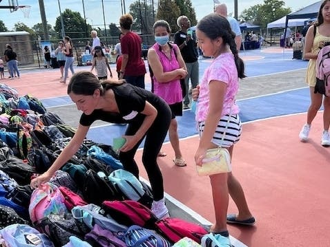 Hundreds of donated backpacks were all lined up for the Lunch Break community program. 