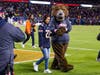 Danielle Jackway walks the field with Chicago Bears mascot, Staley da Bear. 