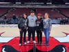 Amber Costa and her family post at the center of the court for a picture. 