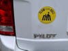 A Slow Your Roll magnet on the back of a car.