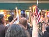 Raising candles on Main in memory of Finney's bartender.