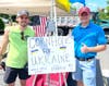 Realtor Brandt Mickolas from the Dave Marcolla Group and James Hill from Edge Insurance Agency raising funds for the Ukraine at the NBA's Cornhole Game.