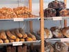 An assortment of baked goods fill the shelves.