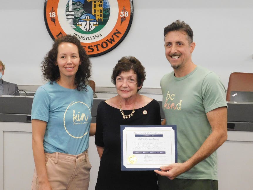 Kristina and Keith Fenimore accept a proclamation from Doylestown Borough Mayor Noni West recognizing them for their work with the Kin Wellness and Support Center.