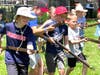 Youngsters charge the field with pretend muskets.