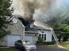 Smoke pours from the roof of the Newtown Gate townhouse.