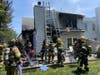 Firefighters conduct overhaul operations after extinguishing the fire. 