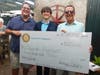 Outgoing Rotary Club President Kyle Davis, left, and Rotarian Rick Rogers, right, present the Rotary Club's Four Way Test Scholarship to David Wenger, center.