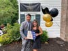 A representative from U.S. Congressman Brian Fitzpatrick's office presents Julie Haines with a flag flown over the U.S. Capitol building