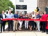 Political and business leaders join Julie Haines in cutting the ribbon on her new agency on North State Street in Newtown Borough.