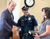 Mayor Larry Keller welcomes the borough's newest full-time officer, Cole Midwood, to the force. Cole's mother looks on.