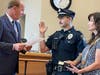 Mayor Larry Keller administers the oath of office to the borough's newest full-time officer, Cole Midwood. Cole's mother, Nancy, is holding the Bible.