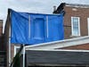 A tarp covers the windows of the Newtown Borough apartment where Scott Krukowski lived  at the time of the fire.