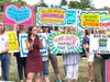 Opponents of the library materials policy rally outside the school district offices in Doylestown.