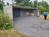 The truck spilled its load of gravel into a field.