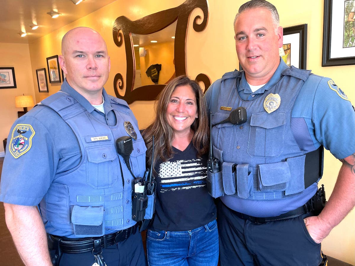 Christina Nelson with Newtown Borough Police Officer Charles Gorski, left, and Corporal Sean Orr, right.