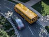 A vehicle breaks the law by passing a bus with its stop sign extended and its lights flashing.