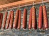 Salami hanging from the ceiling inside the deli adds to the atmosphere inside the new deli-restaurant.