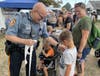 Officer Jules Ferraro hands out stickers at the Middletown Grange Fair.