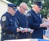Reading the names of the Bucks Countians killed on Sept. 11, 2001, are, from left, Newtown Borough Police Corporal James Warunek, Newtown Ambulance Battalion Chief Kevin Gordon and Newtown Fire Association member Bill Wise