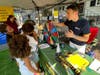 Matt Peters fro A Weed Man shares information with a group of youngsters.