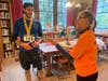 Donna Gusty presents Nick Sava, 29, of Newtown, with a gift certificate for being the first male to cross the finish line.