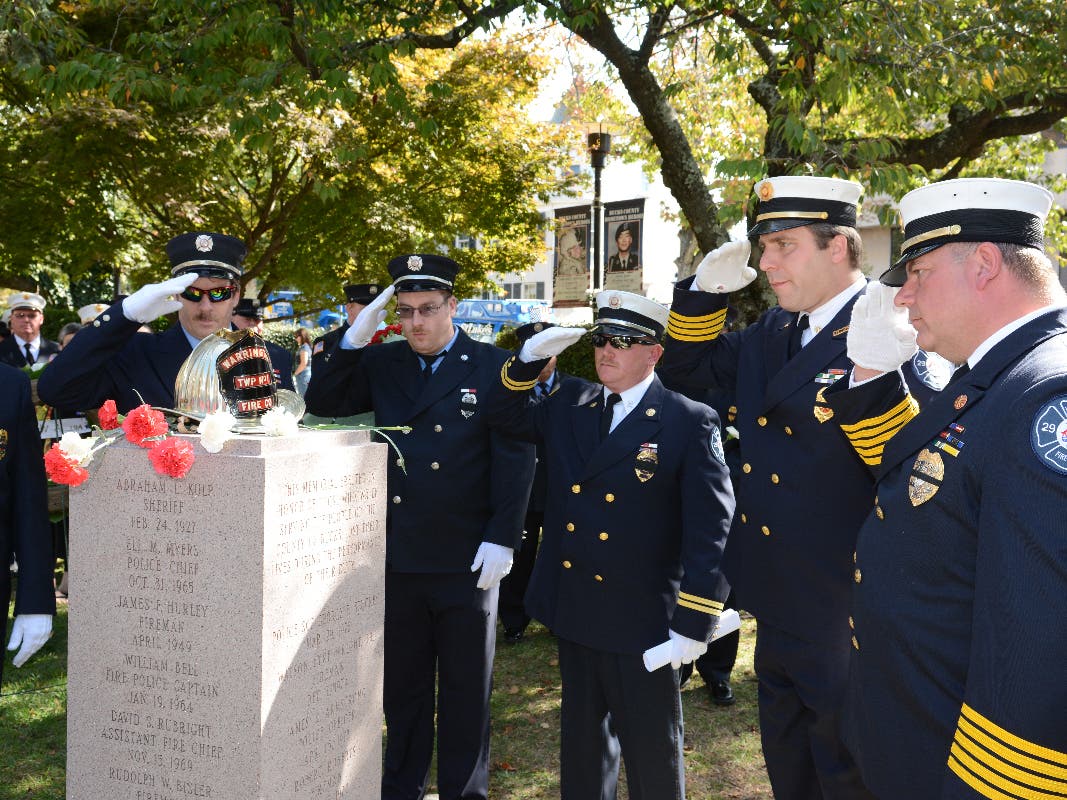 Firefighters salute at the Bucks County Fallen Firefighters Memorial in Doylestown.