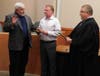 Mayor John Burke holds the bible as former Mayor Dennis O'Brien takes the oath as Newtown Borough's newest councilor. The oath is administered by Judge Mick Petrucci.