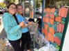 Scarlett and Brooke work on a scene from Charlie Brown's "The Great Pumpkin" on the front window at Starbucks.