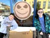 Jackson Lumma and Cole Freeman next to an image of Skellington appearing in a Cup of Joe. The artwork on the side window at Starbucks was created by the Lumma and Freeman families.