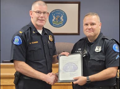 New Britain Township Police Chief Richard Clowser presents a Citation of Commendation to Patrol Officer First Class Paul Zielinski.