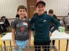 Helping to sort, label and transport over 15,000 pounds of donated food destined for area hunger relief organizations are Zach Luber, 13, and Jeremy Leon, 13, both of Newtown. 