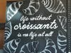 A sign on the wall reads, "Life without croissants is no life at all."