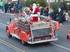 Santa waves to the crowds along Sycamore Street.