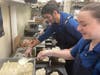 Preparing meals for the hungry at Colonial Farms.