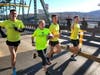 The West Point Marathon Team carries an Army-Navy game ball into New Hope Borough after crossing into Pennsylvania from New Jersey.