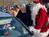 Gene Epstein joined Santa Claus in handing out $100 bills at drive-through food distribution event in Bristol.