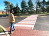 Newtown Walk resident Charlie Feuer prepares to cross the Newtown-Yardley Road at the mid-block crosswalk.