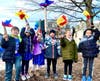 The children from Temple Judea lift their Hanukkah lights into the air during the celebration.