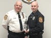 Chief Hearn congratulates Officer Helvig on earning the Top Gun award.