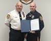 ​Chief Hearn presents Officer Helvig with a Letter of Commendation.