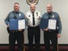 ​Chief Hearn, center, presents Commendations for Life Saving to Corporal Deppi, left, and Sergeant Bartle.