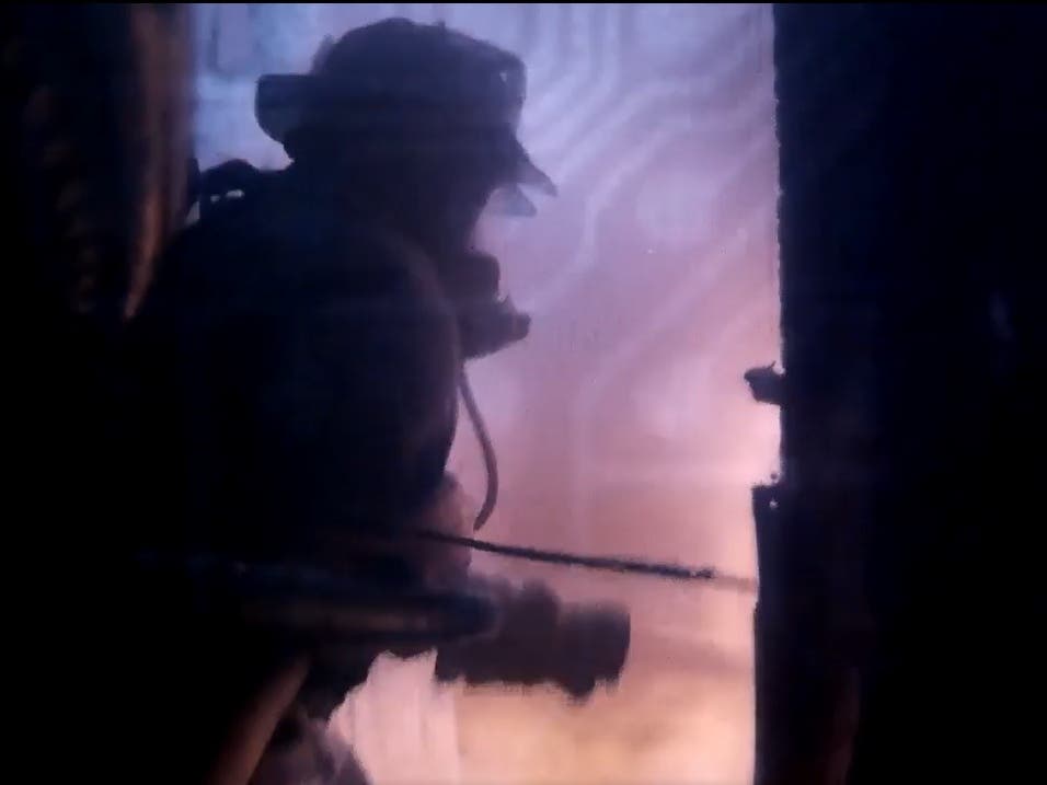 A firefighter battles a fire at an apartment building on Tuesday.