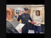 Officer Easton R. Weaver takes the oath as his wife, Gina, holds the bible.