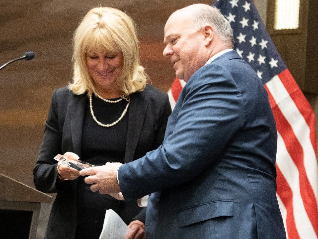 Cox Automotive President Steve Rowley presents the Woman of the Year Award to Beth Beans Gilbert, the vice president of the Fred Beans Automotive Group.