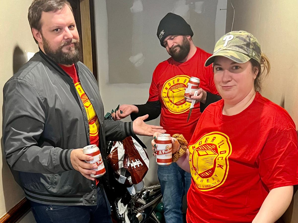Wearing Red and Gold, Neshaminy Creek employees drown their sorrows while carrying out their Super Bowl bet.