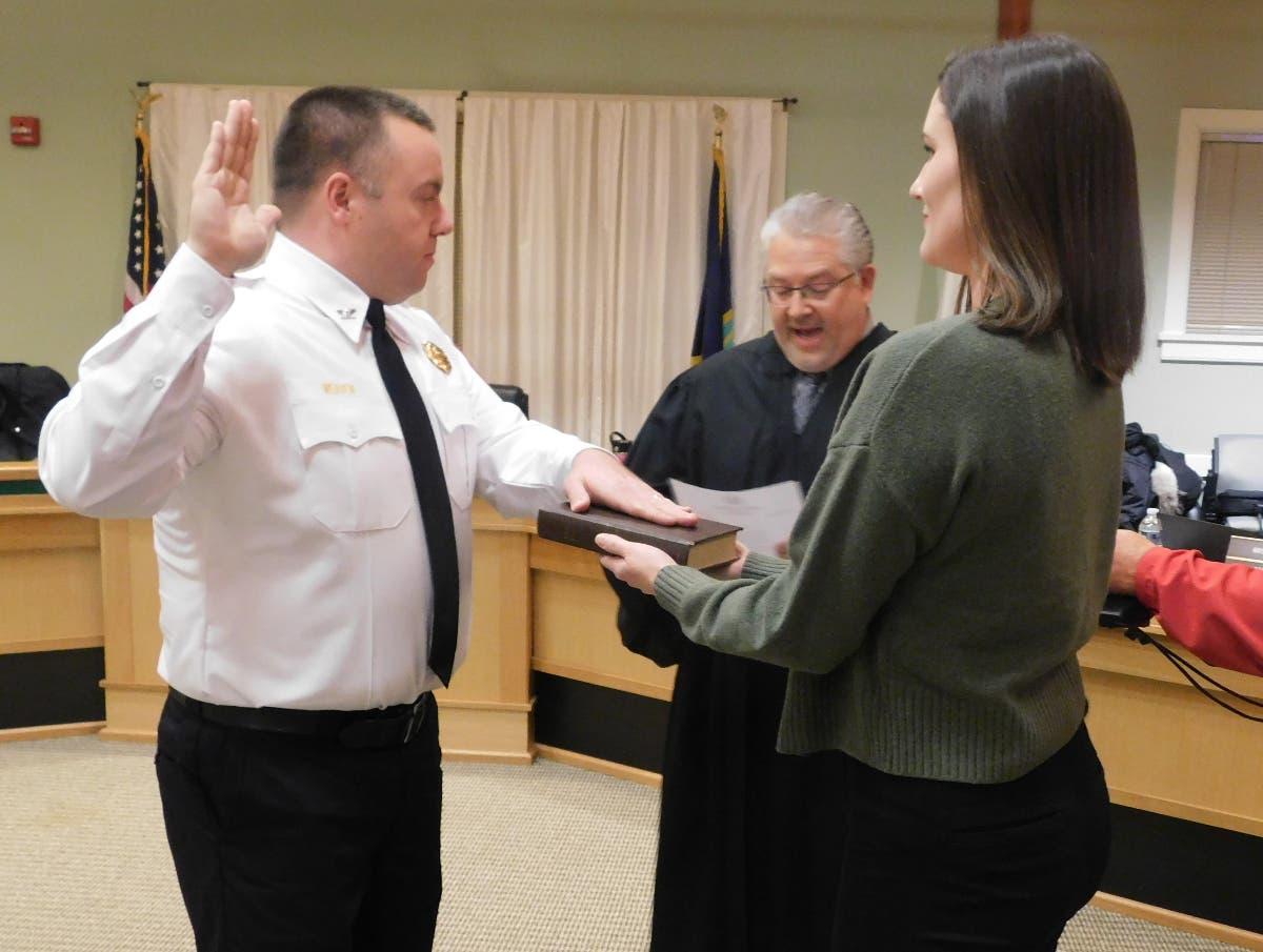 Nicholas Weaver is sworn in by District Judge Mick Petrucci as Weaver's wife, Erin, holds the Bible.