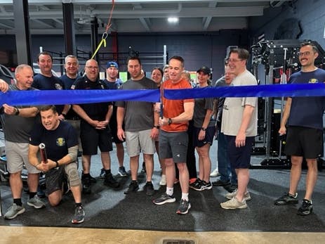 State Senator Steve Santarsiero prepares to cut the ribbon on the new gym at the Doylestown Fire Company's substation.